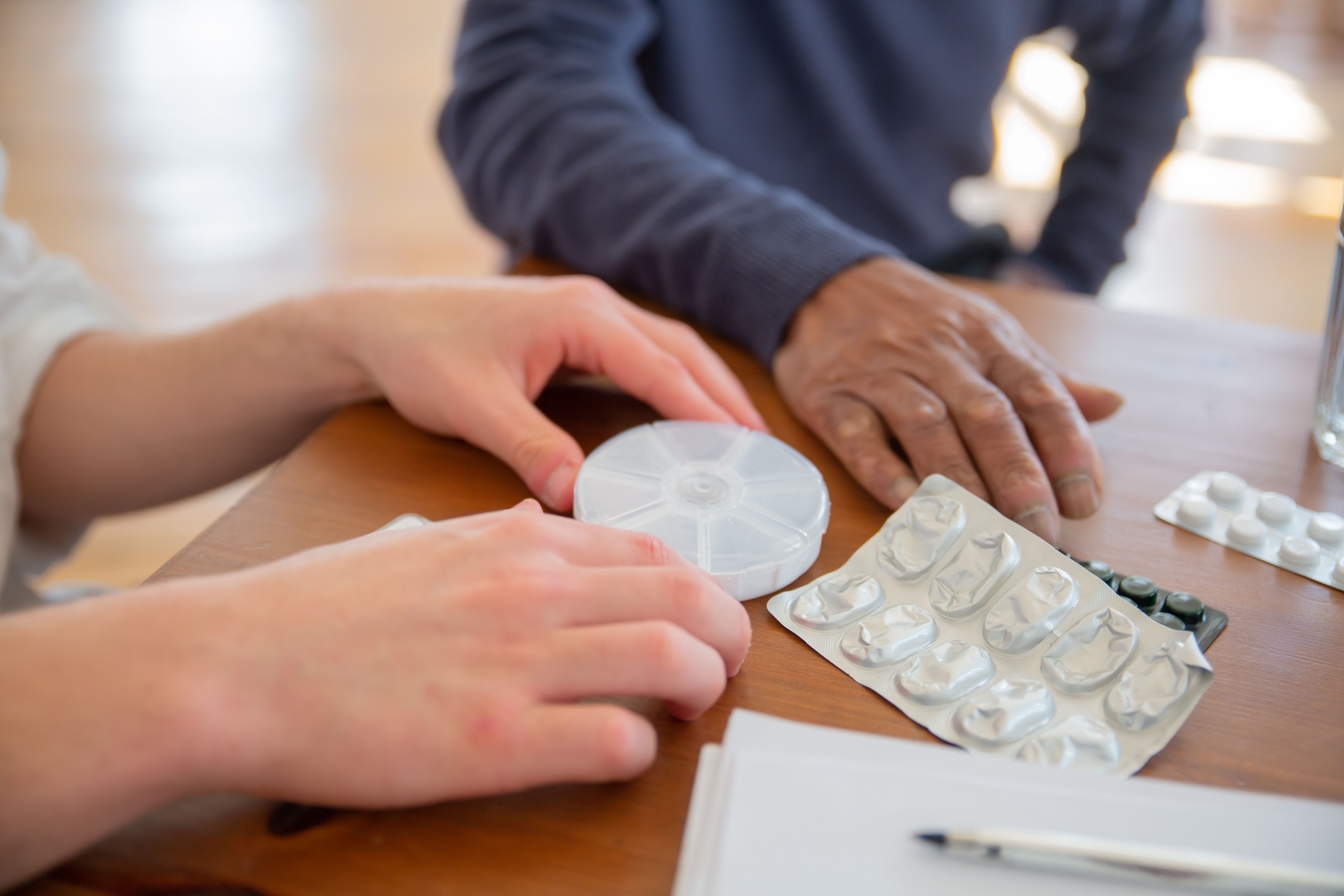 Caregiving planning notes, phone, and medication checklist